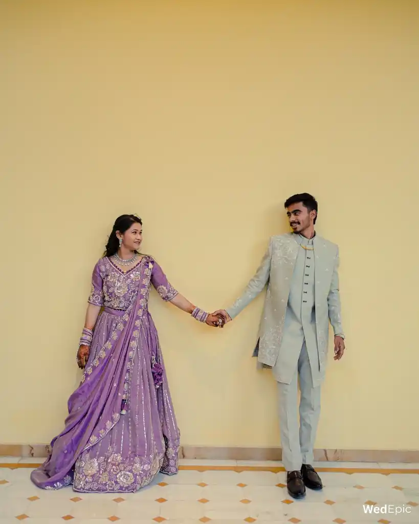 Couple in lilac and sage against a pale yellow wall